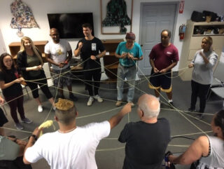 group of people connected by strings
